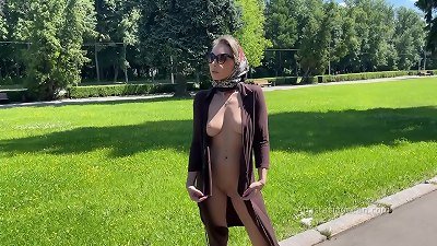 trendy chick walks bare in park. Public